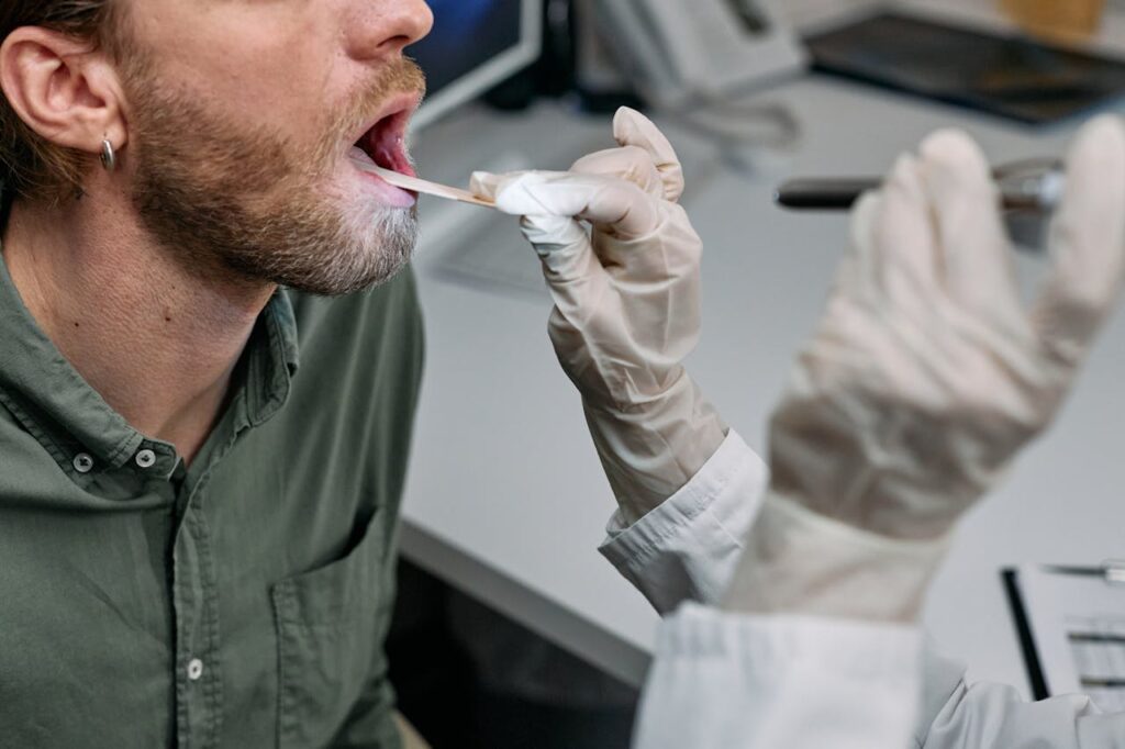 Mastering the First Impression: Your intriguing post title goes here Close-up of a doctor examining a patient's throat with a tongue depressor in a clinical setting.